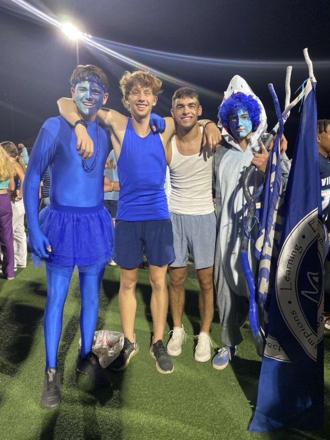 Landon Williams, James Behlke, Ned Joyce, and Bryson Howell pose in their blue out/under the sea outfits at a football game