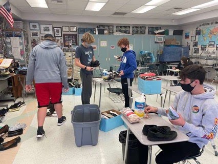 Interact club members James and Owen Behlke, Keegan McGreggor and Ethan Besnard sort shoes from shoe drive